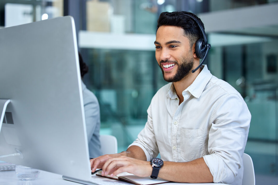 Support agent working at his desk with a headset