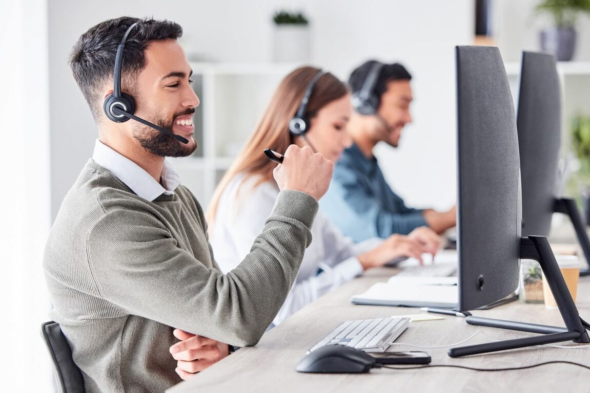 Support agent smiling at her desk